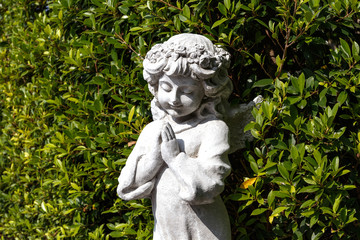 Statues of Guardian angels in green garden