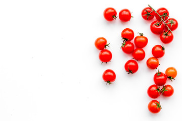 Naklejka na ściany i meble Fresh red cherry tomatoes scattered on white background top view copy space
