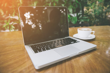 Coffee cup , laptop in coffee shop - vintage effect style pictures