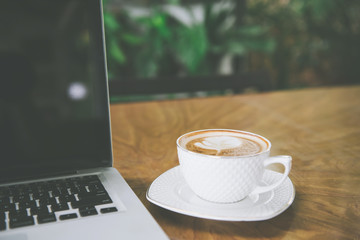 Coffee cup , laptop in coffee shop - vintage effect style pictures