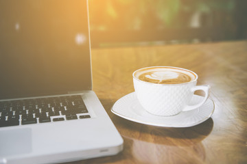 Coffee cup , laptop in coffee shop - vintage effect style pictures