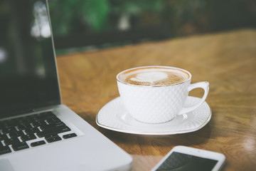 Coffee cup , laptop in coffee shop - vintage effect style pictures