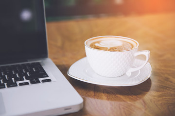 Coffee cup , laptop in coffee shop - vintage effect style pictures