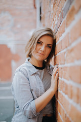 Cute Attractive Young Woman Modeling on Brick Wall