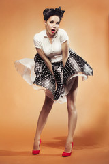 wind suddenly lifted the girl's skirt in pin-up style