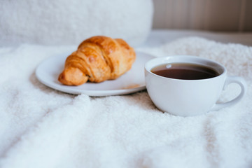 Coffee and croissant in bed