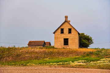Abandoned stucco house in rural Saskatchewan