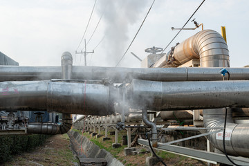 Leakage of steam in heat pipeline interior industrial gas with a lot of piping. Steam valve piping...
