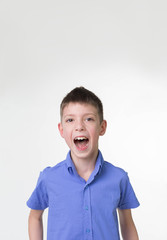 Portrait of shouting teen boy. Happy teenager wearing t-shirt.