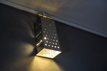 Warm lighting coming out from beautiful home made diy kitchen grater and lamps on wall
