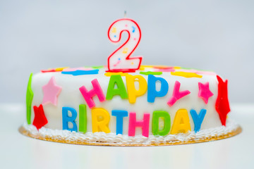 big beautiful cake for a happy birthday with candles in the form of two