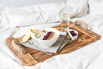 Chia pudding with nuts and fruits. Breakfast in bed on a tray. View from above. - obrazy, fototapety, plakaty