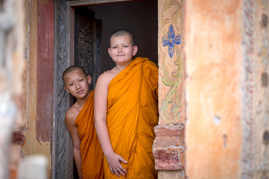Two novices are looking in the temple of Buddhism in Thailand in Asia.