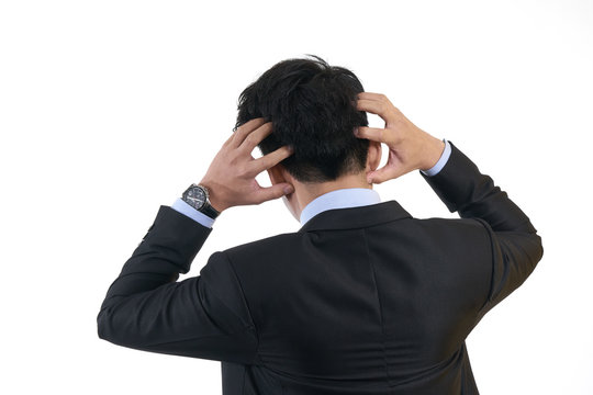 Businessman wearing a black suit. Pretending hand on her head Stress Businesses do not succeed in the wrong plan.using as background business concept with copy space and white space.