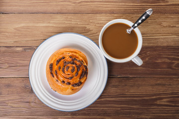 chocolate bun and cup of coffee