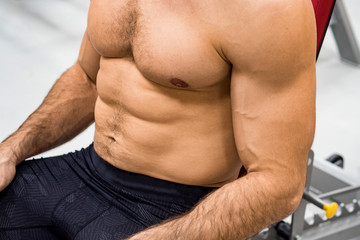Fototapeta na wymiar Close-up torso of male athlete at gym