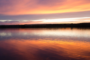Fototapeta na wymiar Beautiful Saskatchewan sunset and reflection over a lake