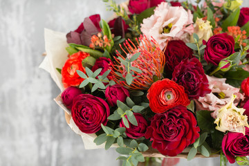 Close-up Beautiful Bouquet. Spring flowers on gray background. flower shop. Wooden table