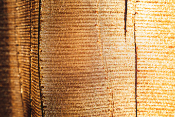 Texture of natural fabric for background illuminated by sunlight..