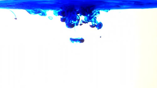 Blue ink in water shooting with high speed camera. Paint dropped, reacting, creating abstract cloud formations metamorphosis on white. Art backgrounds
