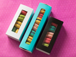 mix of macaroons in colored boxes