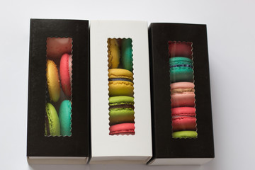 mix of macaroons in colored boxes