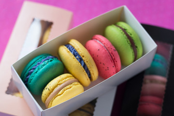 mix of macaroons in colored boxes