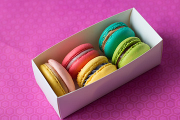 mix of macaroons in white boxes