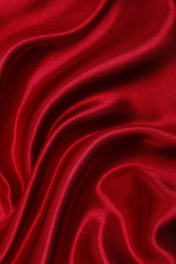Smooth elegant red silk or satin luxury cloth texture as abstract background. Luxurious valentines day background design