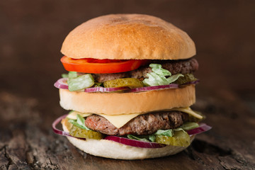 Big hamburger on wooden table