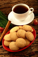 Delicious homemade cookies served with cup of hot black tea.