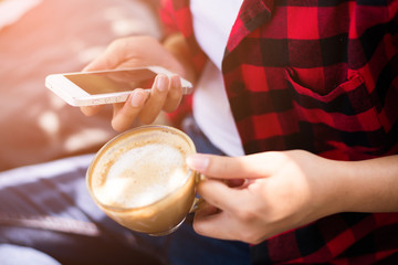 Closeup of female hands holding coffee