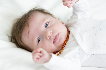 3 month old  beautiful, cute baby with amber necklace