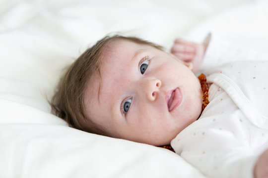 3 month old  beautiful, cute baby with amber necklace