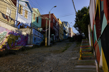 Fototapeta na wymiar Uphill Street in Valparaiso With Buildings and Architecture
