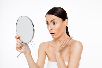Acne. Problems with skin. Cleaning the pores of the skin of the face. Upset young woman saw the...