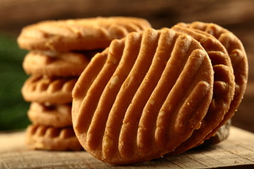Delicious cashew cookies on a wooden background.