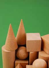 wooden geometric shapes on a green background