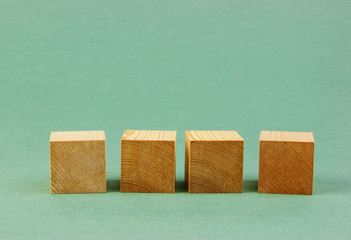 wooden geometric cube on a green background