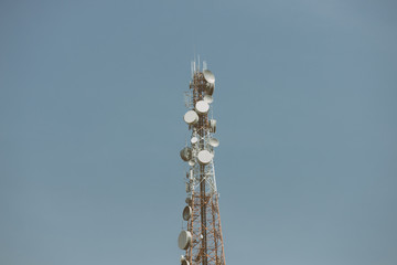 Telecommunication tower with antennas with blue sky
