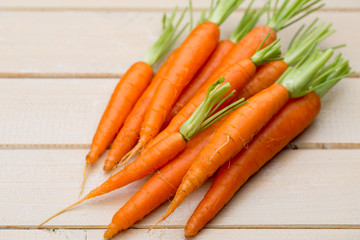 Bunch of fresh asparagus on wooden table.