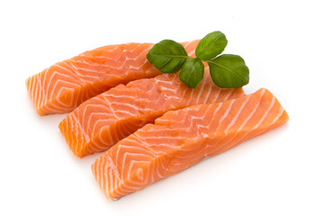 Fresh salmon fillet with basil on the white background.