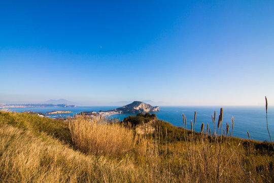 panoramic view of the sea of Naples on a clear day in the summer. The blue sky has no clouds. Vesuvius can be seen in the background