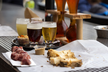 Different types of beer like coconut and cherry beer and cheese with smocked sausage