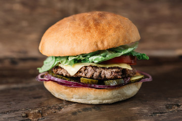 fresh tasty fishburger on wooden table