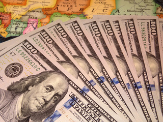 Obraz na płótnie Canvas US dollars on the map of Africa. African economy