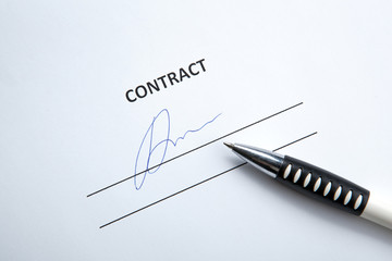 One document with a place for a signature and a pen