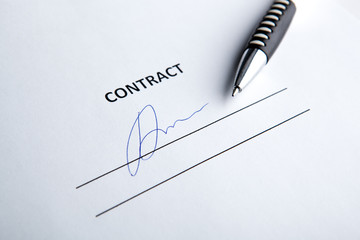 One document with a place for a signature and a pen