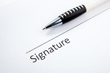 One document with a place for a signature and a pen