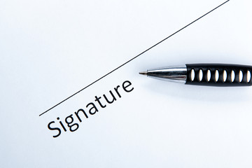 One document with a place for a signature and a pen